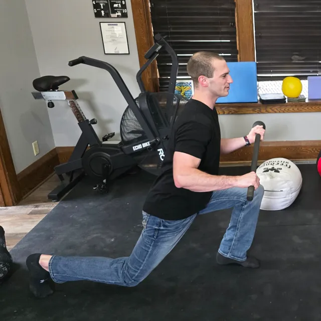 A patient stretching legs in a runners lunge position