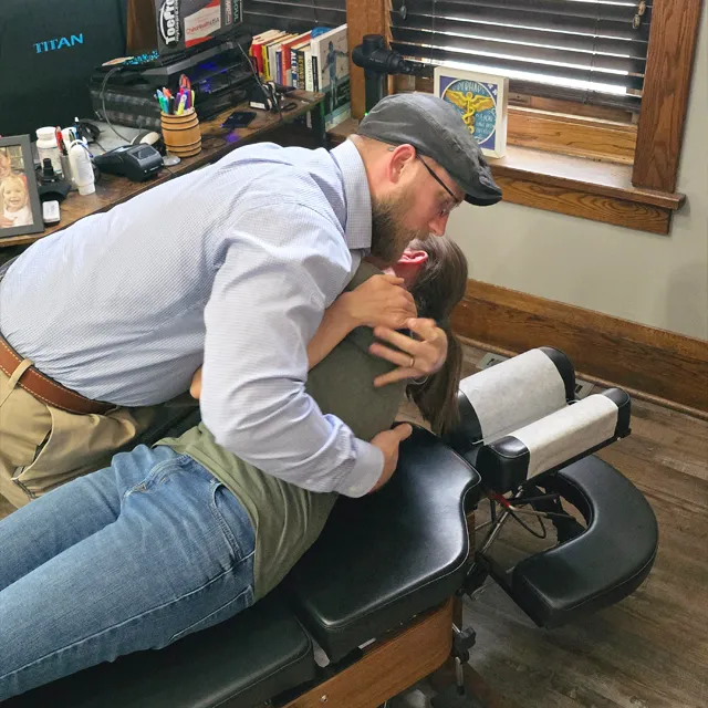 Chiropractor Jacob Stoffel adjust a patients back on an adjustment table