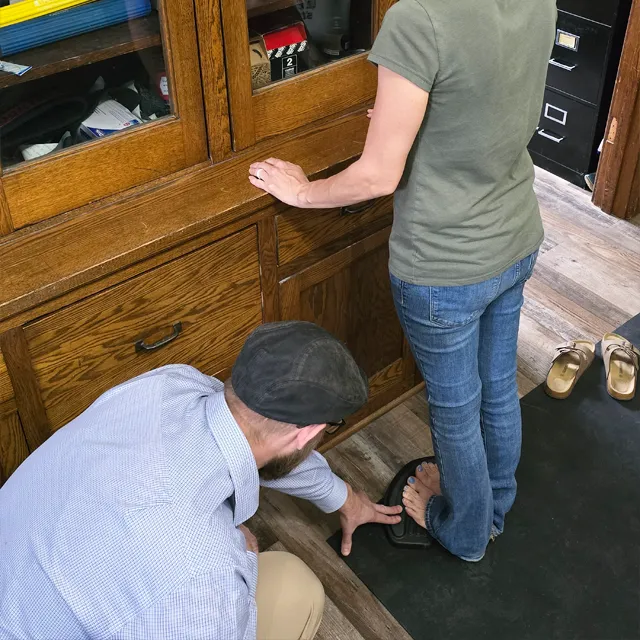 Chiropractor Jacob Stoffel working on the feet of an orthotics patient