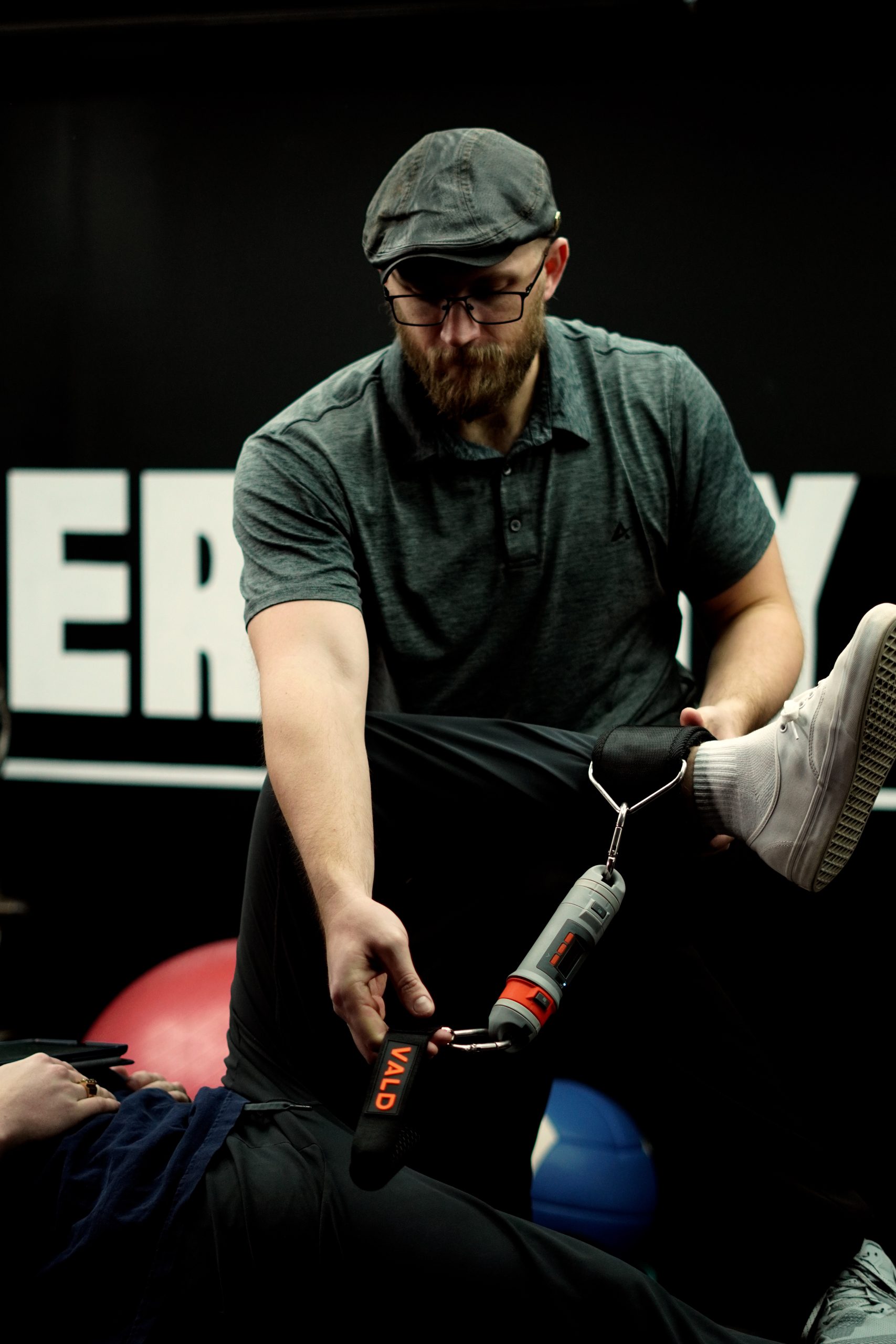 Chiropractor Hudson WI Jacob Stoffel Adjusting Patient Looking Down